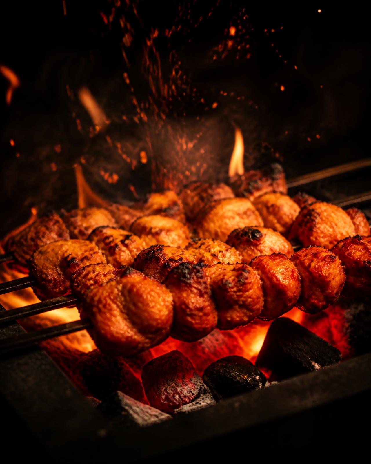 Tandoori skewers over glowing charcoal